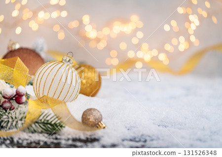 Elegant Christmas Baubles and Ribbon on Snow with Lights Elegant Christmas Baubles and Ribbon on Snow with Lights 131526348