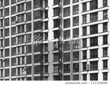 Close up of modern high rise residential building facade. Multiple glass windows and balconies 131526666