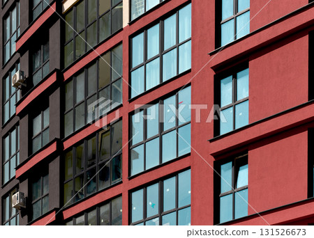 Close up of modern highrise apartment building. Multiple glass windows and balconies form geometric 131526673