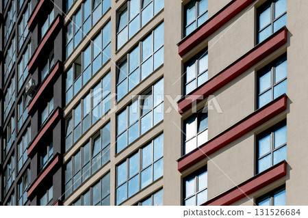 Close up of tall high rise residential building. Multiple windows and balconies create geometric 131526684