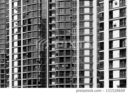 Close up of tall modern urban tower. Glass windows and balconies create geometric facade pattern. Close up of tall modern urban tower. Glass windows and balconies create geometric facade pattern. 131526689