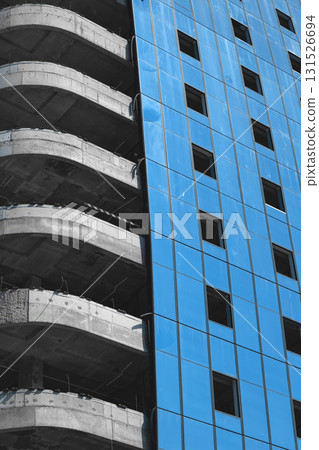 Closeup of geometric glass windows and balconies on tall highrise residential tower in metropolitan 131526694