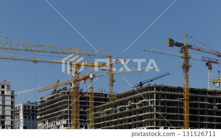 Construction cranes over high rise complex with steel framework and concrete structure in Construction cranes over high rise complex with steel framework and concrete structure in 131526711