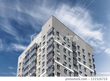 Contemporary apartment building in city. Tall multistory residential tower with balconies and modern Contemporary apartment building in city. Tall multistory residential tower with balconies and modern 131526728