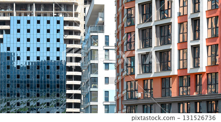 Contemporary multi family building in developing downtown district. Tall residential condominium 131526736