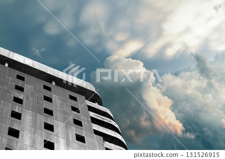Unfinished multi storey tower with steel framework and concrete structure against cloudy sky. Modern Unfinished multi storey tower with steel framework and concrete structure against cloudy sky. Modern 131526915