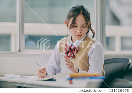 Female junior high school student studying in a cram school classroom Female junior high school student studying in a cram school classroom 131526978