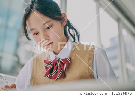 Female junior high school student studying in a cram school classroom Female junior high school student studying in a cram school classroom 131526979
