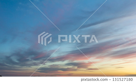 Colorful sunset skies filled with clouds over a tranquil horizon during the evening hours Colorful sunset skies filled with clouds over a tranquil horizon during the evening hours 131527180