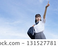 High school student pointing towards the blue sky 131527781