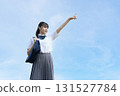 High school student pointing towards the blue sky 131527784