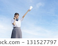 High school students cheering with a blue sky in the background 131527797