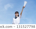 High school students cheering with a blue sky in the background 131527798