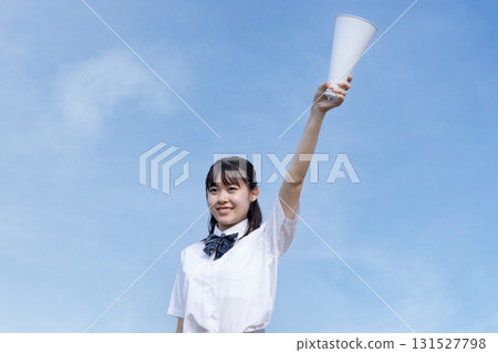 High school students cheering with a blue sky in the background High school students cheering with a blue sky in the background 131527798