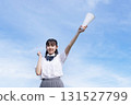High school students cheering with a blue sky in the background 131527799