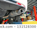 Car exhaust pipe and muffler close up under vehicle on lift 131528300