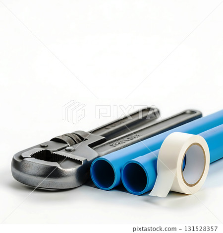 Adjustable wrench beside two blue pipes and a roll of white sealing tape. Background is out of focus, emphasizing the tools. The wrench has textured grip and shiny surface Adjustable wrench beside two blue pipes and a roll of white sealing tape. Background is out of focus, emphasizing the tools. The wrench has textured grip and shiny surface 131528357