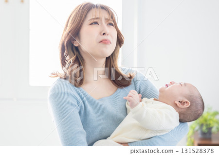 A mother holding a baby 131528378