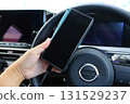 Woman charging her smartphone in a car Image Driving 131529237