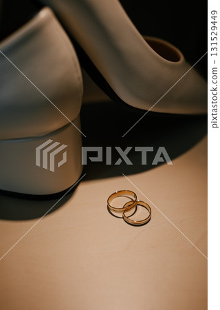 Gold Wedding Rings with White Bridal Shoes Display Gold Wedding Rings with White Bridal Shoes Display 131529449