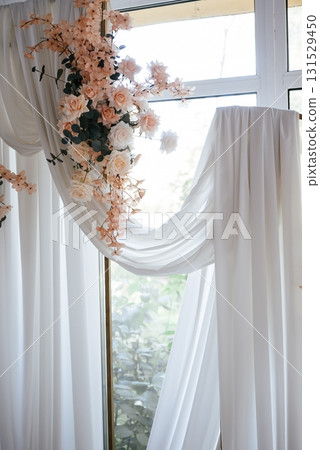 Elegant Floral Arrangement with Draped White Curtains 131529450