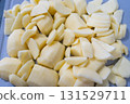 Slice potato on cutting board with knife. Cooking meal 131529711