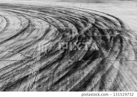 Black tire marks on road, Black rubber tire marks and tread marks, Tire trace track wheels texture and background, Auto tire tread grunge, Car wheel tyre tread track black tyre print. Black tire marks on road, Black rubber tire marks and tread marks, Tire trace track wheels texture and background, Auto tire tread grunge, Car wheel tyre tread track black tyre print. 131529732