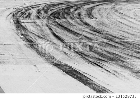 Black tire marks on road, Black rubber tire marks and tread marks, Tire trace track wheels texture and background, Auto tire tread grunge, Car wheel tyre tread track black tyre print. 131529735
