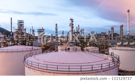 Aerial view oil and gas refinery plant at night, Global business energy logistic transportation, Oil and gas refinery petrochemical industrial, Petrochemical refinery industrial energy supply chain. Aerial view oil and gas refinery plant at night, Global business energy logistic transportation, Oil and gas refinery petrochemical industrial, Petrochemical refinery industrial energy supply chain. 131529737