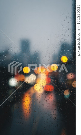 Raindrops On Window With Blurred City Lights In Background. Moody Urban Scene Capturing Rainy Evening Ambiance 131530533