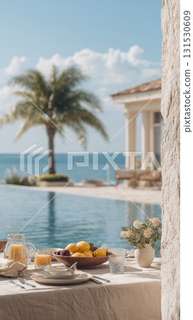 Outdoor Dining Setup By A Pool With Ocean View. Luxurious Tropical Breakfast Scene Outdoor Dining Setup By A Pool With Ocean View. Luxurious Tropical Breakfast Scene 131530609