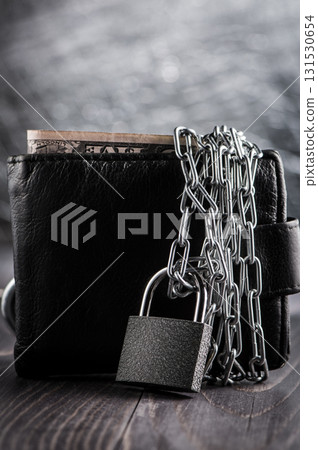 The metal chain covers the wallet with a lock The metal chain covers the wallet with a lock 131530654