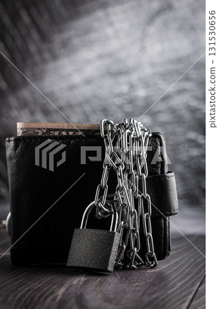 The metal chain covers the wallet with a lock The metal chain covers the wallet with a lock 131530656
