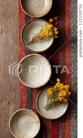 Ceramic Bowls With Yellow Flowers On Rustic Wooden Table. Artistic Table Setting With Natural Elements 131530710