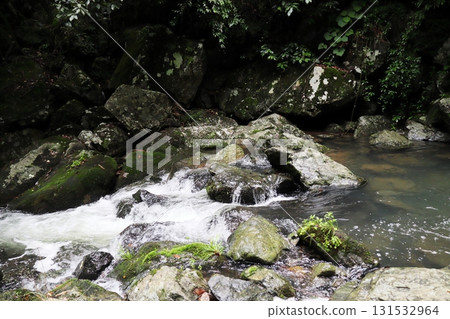 A white waterfall flowing down the black rock face of Hotokebuchi A white waterfall flowing down the black rock face of Hotokebuchi 131532964