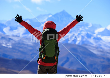 Successful woman hiker open arms to Mount Everest in Tibet, China Successful woman hiker open arms to Mount Everest in Tibet, China 131533148