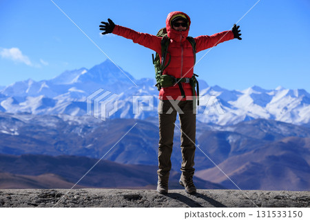 Successful woman hiker open arms to Mount Everest in Tibet, China 131533150
