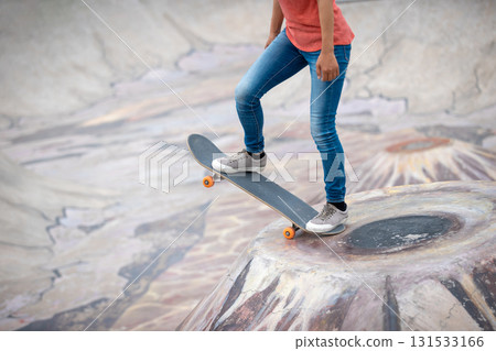 Skateboarder skateboarding at skatepark in city Skateboarder skateboarding at skatepark in city 131533166