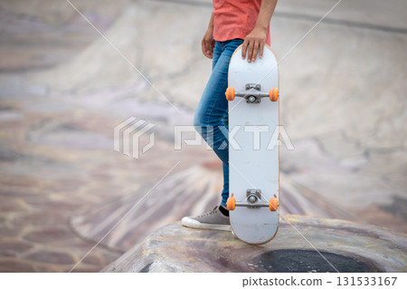 Skateboarder skateboarding at skatepark in city Skateboarder skateboarding at skatepark in city 131533167