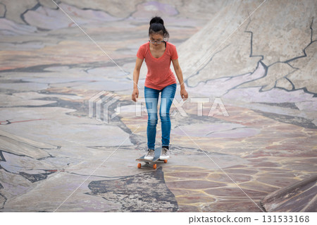 Skateboarder skateboarding at skatepark in city 131533168