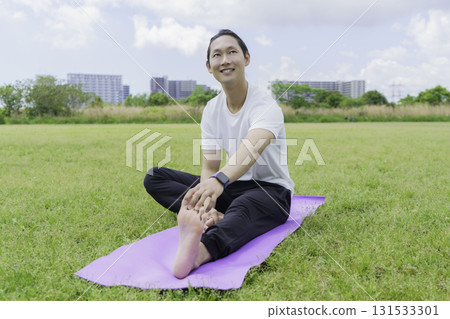 Young man stretching in the park Young man stretching in the park 131533301