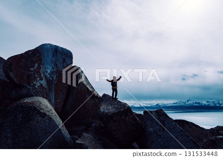 Backpacking woman enjoy the view on high altitude mountain top Backpacking woman enjoy the view on high altitude mountain top 131533448