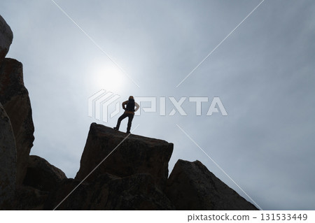 Backpacking woman enjoy the view on high altitude mountain top 131533449