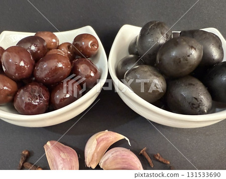 Closeup of green and black olives. Bowls of assorted olives still life. Closeup of green and black olives. Bowls of assorted olives still life. 131533690