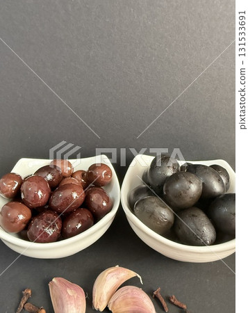 Closeup of green and black olives. Bowls of assorted olives still life. Closeup of green and black olives. Bowls of assorted olives still life. 131533691