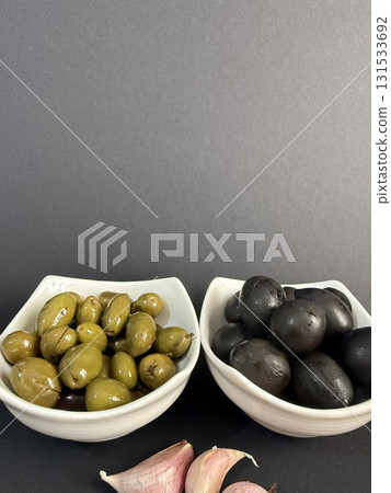 Closeup of green and black olives. Bowls of assorted olives still life. 131533692