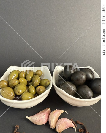 Closeup of green and black olives. Bowls of assorted olives still life. Closeup of green and black olives. Bowls of assorted olives still life. 131533693