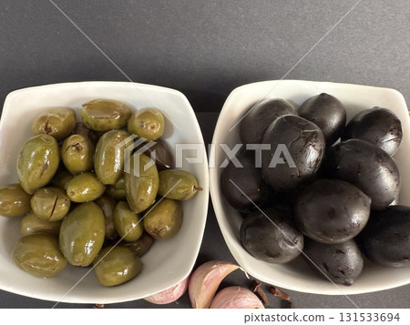 Closeup of green and black olives. Bowls of assorted olives still life. Closeup of green and black olives. Bowls of assorted olives still life. 131533694
