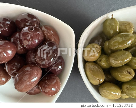 Closeup of green and black olives. Bowls of assorted olives still life. Closeup of green and black olives. Bowls of assorted olives still life. 131533738