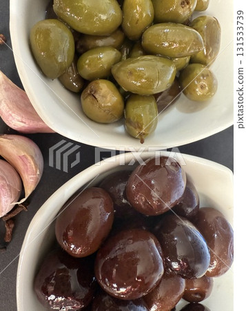 Closeup of green and black olives. Bowls of assorted olives still life. 131533739